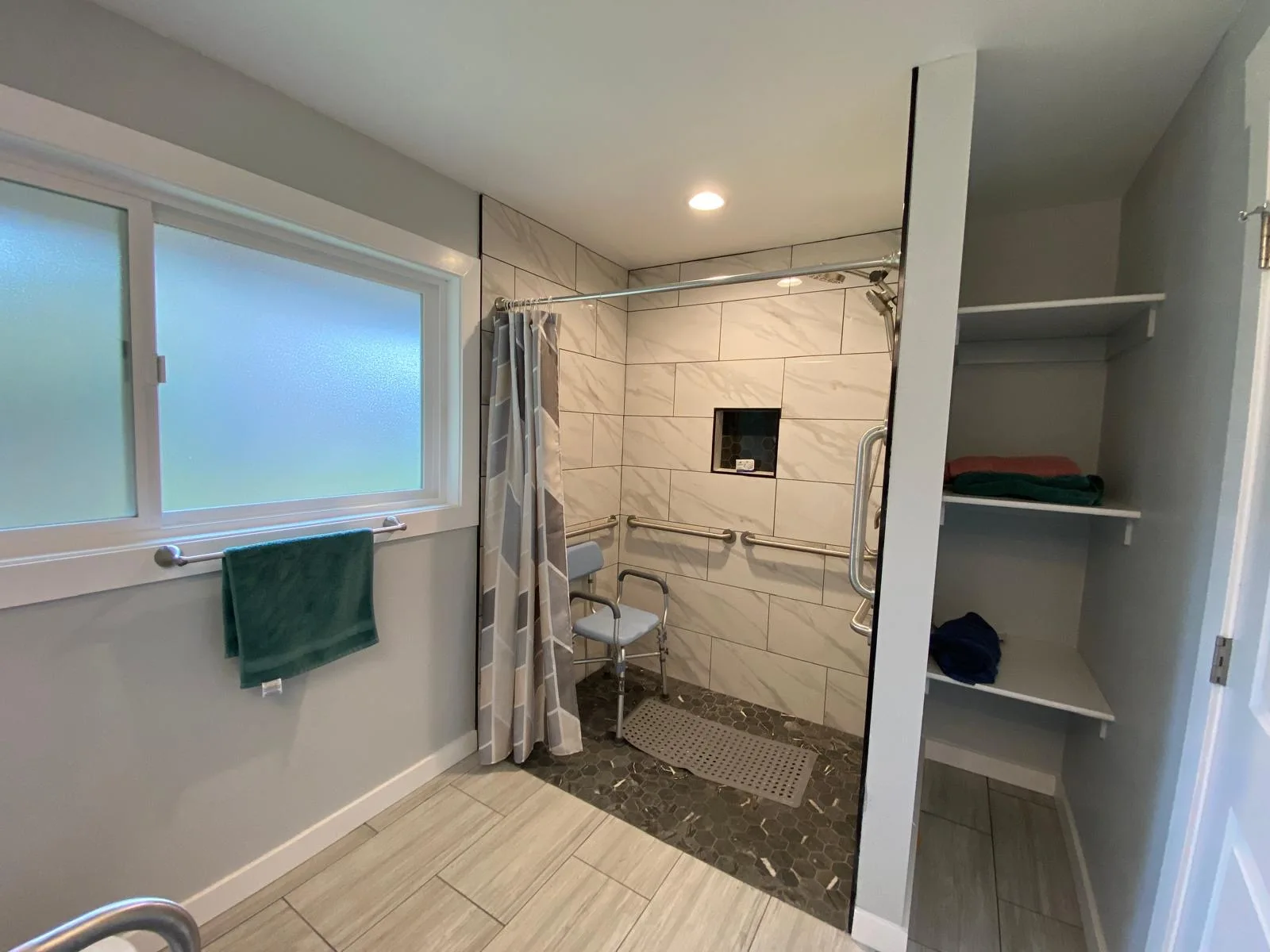 Shower with grab bars and shower chair